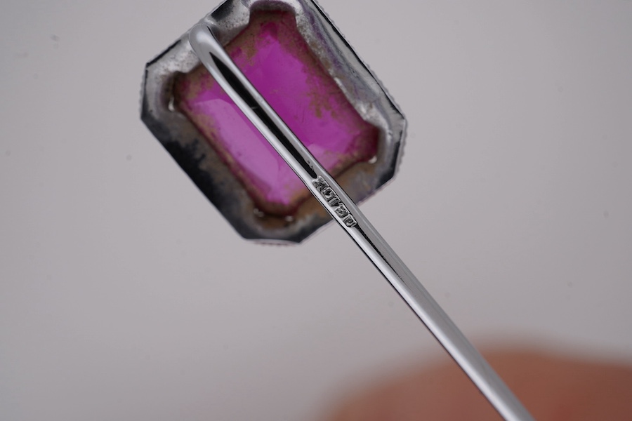 A North American? 10k white metal and single stone emerald cut synthetic ruby set stick pin, 55mm, gross weight 1.1 grams. Condition - fair to good
